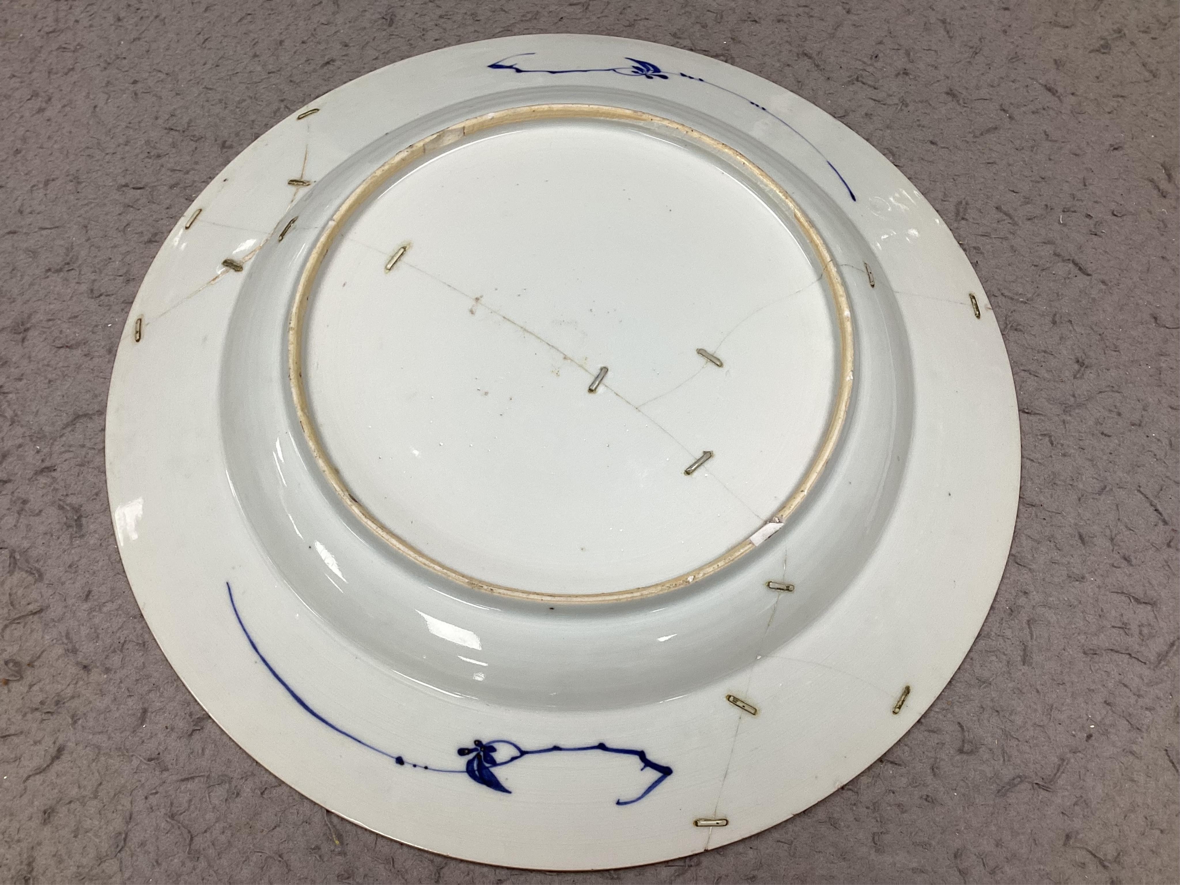 An 18th century Chinese Export serving dish and (repaired) plate, largest 32cm. Condition - poor